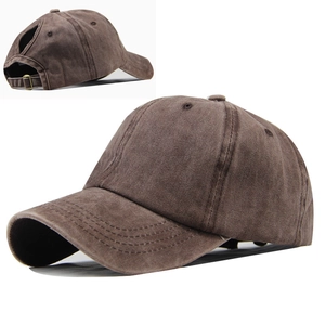 Detail of coffee brown ponytail baseball cap showing washed cotton texture and metal buckle