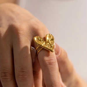 Vintage 18k gold plated titanium heart ring with hammered texture on model hand