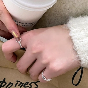 Detail of 925 sterling silver pig nose ring and pink crystal ring on model's hand