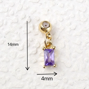 Macro detail of a 14mm x 4mm gold-plated purple gemstone charm pendant for jewelry DIY
