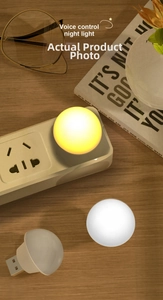 Macro shot of a USB voice-controlled spherical night light glowing on a wooden table