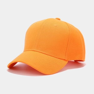 Detail view of stitching and texture on an orange cotton baseball cap with curved brim