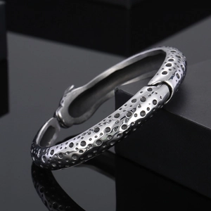 Silver punk leopard open bangle featuring a unique textured industrial metal surface