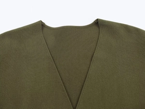 Detailed close-up of V-neckline stitching and olive green knit fabric texture