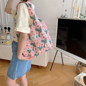 Dettaglio della borsa tote in tela floreale che mostra la trama del motivo a fiori rosa