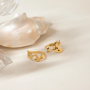 Close-up of bird-themed open rings with 18K gold finish and sparkling zircon detail
