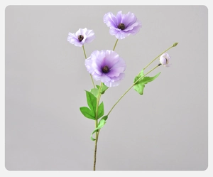 Detailed view of artificial purple ranunculus with three blooming heads and green foliage