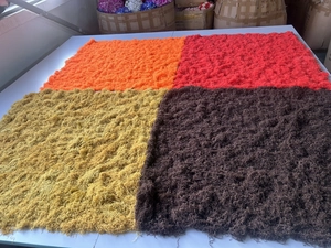 Detailed overhead view of assorted colorful artificial moss turf samples for landscaping