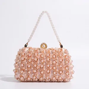 Elegant champagne satin evening bag with handmade roses, pearls, and a pearl chain strap