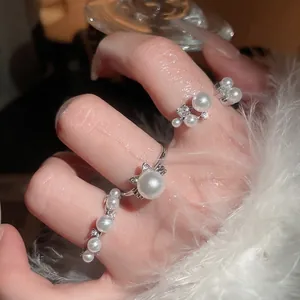 Elegant pearl and zircon cat ear ring set in silver finish on hand with soft lighting