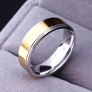 Macro shot of 6mm two-tone stainless steel ring with gold stripe on jewelry velvet