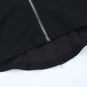 Macro detail of the metal zipper and stitching on the black lace camisole top