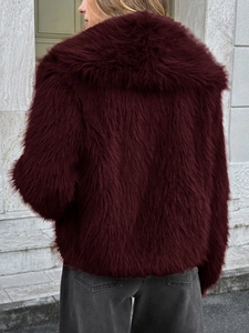 Rear view of fluffy burgundy faux fur coat showing soft texture and glossy finish