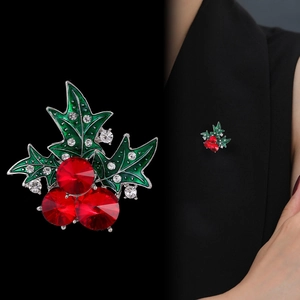 Elegant Christmas cherry brooch with green enamel leaves and red crystal berries on suit