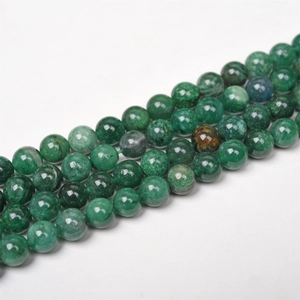Macro shot of natural green mica round beads with unique stone textures for DIY jewelry