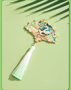 Close-up of fan-shaped Hangzhou fridge magnet with Leifeng Pagoda and white silk tassel