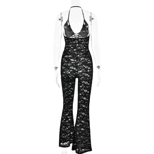 Detail of the backless halter design and lace texture on black flared jumpsuit