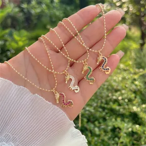 Handheld view of a 18K gold plated dragon necklace with colorful zircon stones