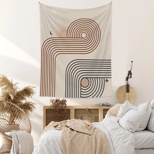 Detail of bohemian tapestry featuring sun and moon patterns in a cozy bedroom