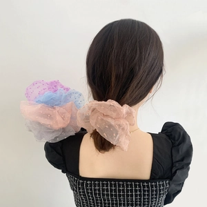 Polka dot mesh lace scrunchies in pastel colors worn on hair and held in hand