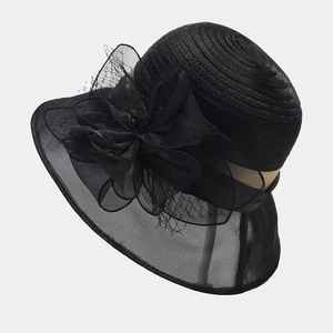 Detailed side view of organza flower decor and champagne ribbon on black sun hat
