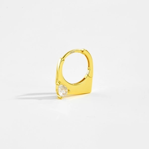 Macro detail of S925 sterling silver hallmark on golden heart-shaped zircon hoop earring
