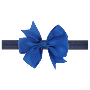 Detail of blue grosgrain ribbon bow on elastic baby headband with ribbed texture