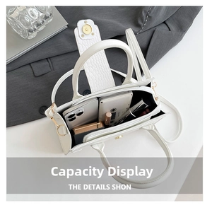 Internal view of a white crocodile embossed handbag showing ample space for daily essentials