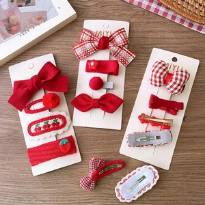 Red festive hair clips set with fabric bows and strawberry motifs for girls and women