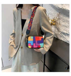 Close-up of stylish crossbody bag with colorful geometric blocks and wide strap