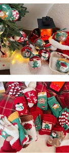 Detail of soft Christmas coral fleece socks packaged in a clear decorative gift ball