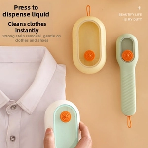 Detail showing the liquid dispensing button and soft bristles of the cleaning brush set