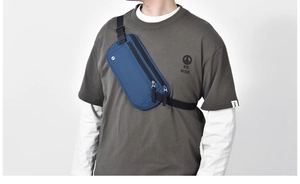 Close-up of blue waterproof RFID waist bag with black zippers and adjustable strap