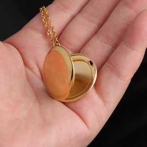 Macro shot of an open golden heart locket necklace showing the internal photo space