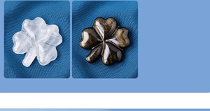 Detailed comparison of polished clear crystal and black obsidian four-leaf clovers