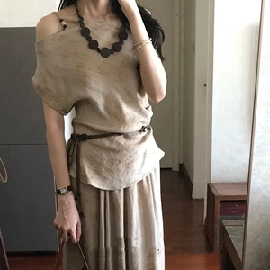 Bohemian wooden bead necklace paired with minimalist beige linen top and skirt set