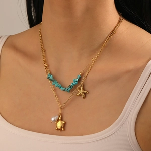 Double-layer necklace with sea turtle, starfish, blue stone beads and pearl charms on model