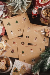 Detail of Christmas tree and reindeer kraft paper gift tags for festive packaging