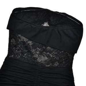 Detail view of black strapless dress featuring lace mesh panel and ruched fabric texture
