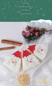 Detailed view of red Santa Claus scented candle with cinnamon and festive decor