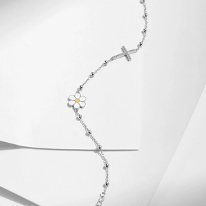 S925 sterling silver bracelet featuring white daisy and sparkling diamond cross pendant