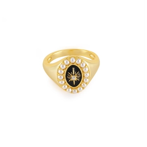 Detail of vintage gold ring with black enamel, starburst zircon, and pearl border