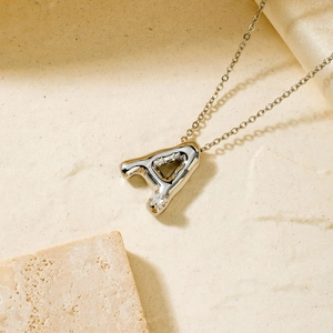 Detailed view of silver letter A pendant necklace with a sparkling zircon accent