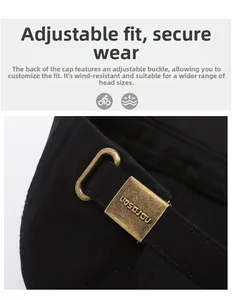 Detail of adjustable bronze metal buckle on a black twill cotton baseball cap