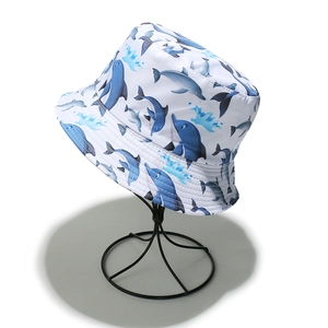 Detail of white bucket hat featuring blue dolphin prints and quick-dry fabric texture