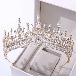 Close-up of gold bridal crown with marquise crystals in a white presentation box