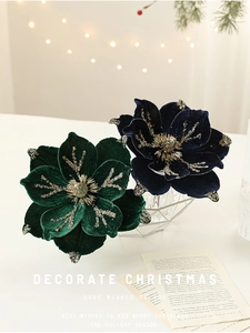 Close-up of luxury dark green and navy velvet Christmas flowers with gold glitter accents