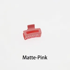Close-up of a matte pink rectangular hollow hair claw clip with a multi-tooth design