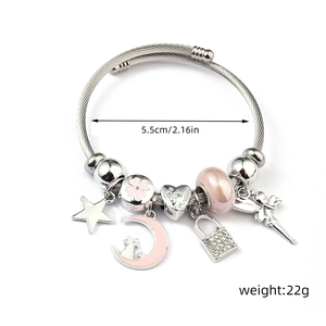 Detailed view of silver charm bracelet with pink moon, enamel star and Valentine heart