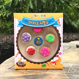 Detail shot of mini cartoon dessert erasers with colorful cream frosting in a gift box